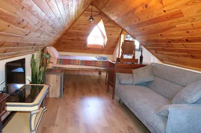 a living room with a couch and a bed at Quinta do Ribeiro Real in Câmara de Lobos