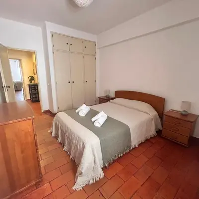 a bedroom with a bed with two towels on it at MarLuz in Luz