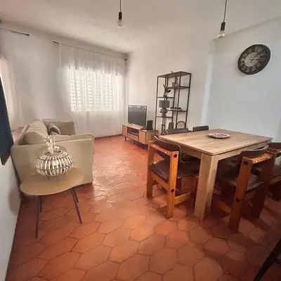 a living room with a wooden table and chairs at MarLuz in Luz
