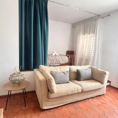 a living room with a couch in front of a window at MarLuz in Luz