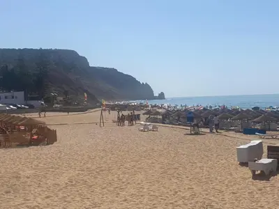 a group of people on a beach with the ocean at MarLuz in Luz