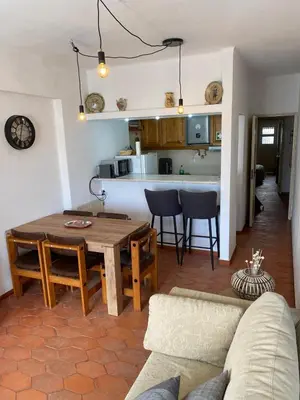 a kitchen and living room with a table and chairs at MarLuz in Luz