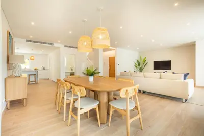 a dining room and living room with a wooden table and chairs at Tropical Beach Villa by Blue Diamond 21 in Lagos