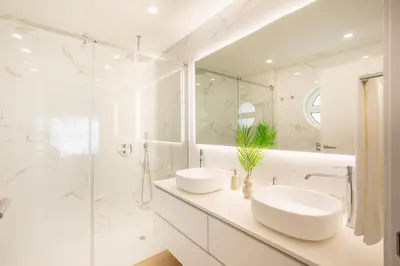 a white bathroom with two sinks and a shower at Tropical Beach Villa by Blue Diamond 21 in Lagos