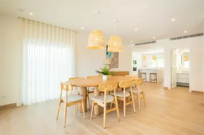 a kitchen and dining room with a wooden table and chairs at Tropical Beach Villa by Blue Diamond 21 in Lagos