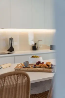 a kitchen counter with a tray of food on a table at Savoy Monumentalis V by An Island Apart in Funchal