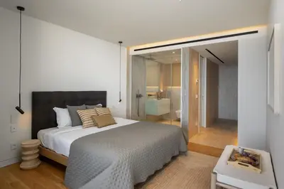 a bedroom with a large bed and a bathroom at Savoy Monumentalis V by An Island Apart in Funchal