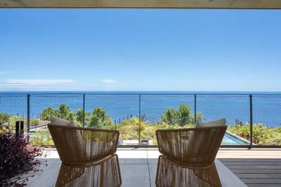 two chairs on a balcony with a view of the ocean at Savoy Monumentalis V by An Island Apart in Funchal