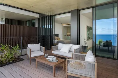 a living room with a patio with a view of the ocean at Savoy Monumentalis V by An Island Apart in Funchal
