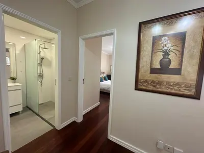 a bathroom with a painting of a vase on the wall at Robert Apartment in Ajuda in Funchal