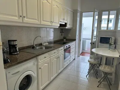 a kitchen with a sink and a washing machine at Robert Apartment in Ajuda in Funchal