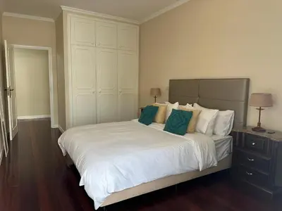 a bedroom with a large white bed with green pillows at Robert Apartment in Ajuda in Funchal