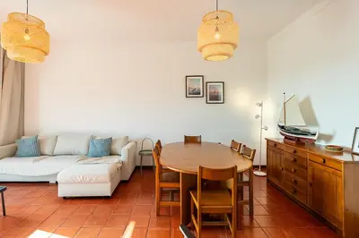 a kitchen with a table and a microwave at Sailor House - By Wehost in Porto Santo