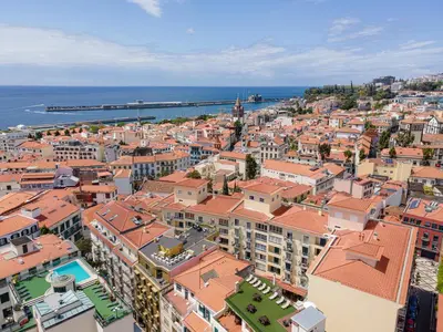 an aerial view of a city with buildings and the ocean at Funchal Heart Studio in Funchal