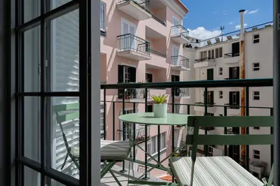 a balcony with a table and chairs and a window at Funchal Heart Studio in Funchal