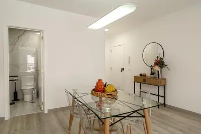 a dining room with a glass table and a mirror at Funchal Heart Studio in Funchal