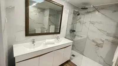 a white bathroom with a sink and a shower at Peaceful beachside Penthouse - 3 Bed 608 in Funchal