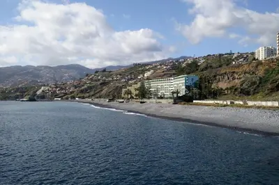 a view of a beach with buildings on a hill at Peaceful beachside Penthouse - 3 Bed 608 in Funchal