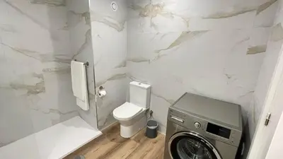 a bathroom with a toilet and a washing machine at Peaceful beachside Penthouse - 3 Bed 608 in Funchal