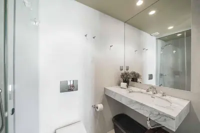 a white bathroom with a sink and a mirror at Villa Fig Tree in Prazeres