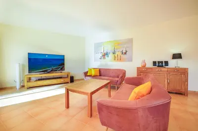a table and chairs in a room with a view of the ocean at Estrela Apartment by Moje Holiday in Luz