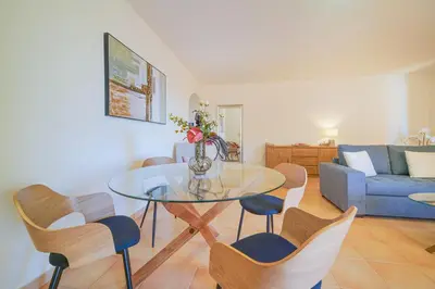 a bedroom with a large white bed with two towels at Estrela Apartment by Moje Holiday in Luz