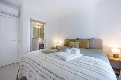 a bedroom with a large bed with towels on it at Alba Villa in Aljezur