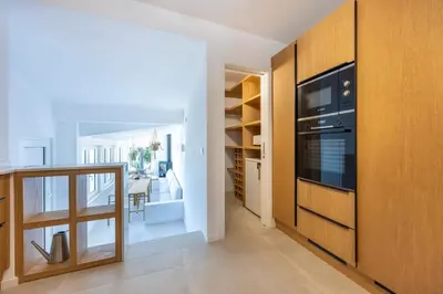 a kitchen and dining room with a stove and cabinets at Alba Villa in Aljezur