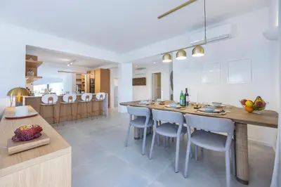 a kitchen and dining room with a large table and chairs at Alba Villa in Aljezur