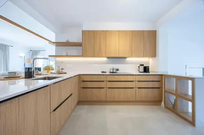 a kitchen with wooden cabinets and a counter top at Alba Villa in Aljezur