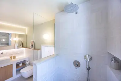 a bathroom with a shower with a toilet and a sink at Alba Villa in Aljezur