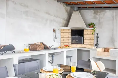 a kitchen with a table with plates on it at Serenity View by YOUR KEY in Funchal