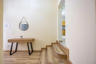 a hallway with a table and a mirror on the wall at Serenity View by YOUR KEY in Funchal