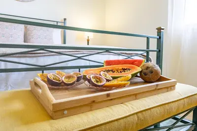 a tray of fruit sitting on top of a bed at Serenity View by YOUR KEY in Funchal