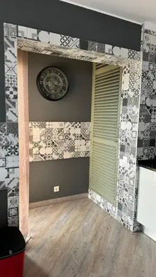 a room with a clock on the wall and a door at Grayscale Studio in Caniço