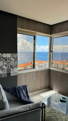 a living room with a view of the ocean at Grayscale Studio in Caniço