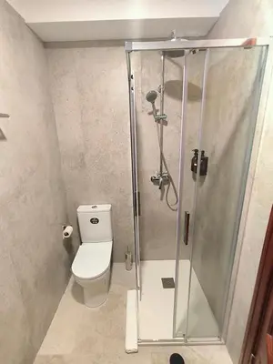 a bathroom with a toilet and a shower at North Madeira Guesthouse in Seixal