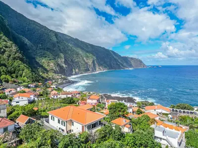 an aerial view of a small town next to the ocean at North Madeira Guesthouse in Seixal