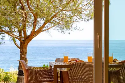 a table with a view of the ocean at The Oceanfront Villa Luz VR114 in Luz