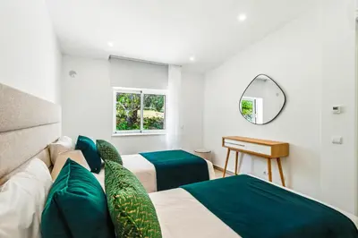 a bedroom with two beds and a mirror at The Oceanfront Villa Luz VR114 in Luz