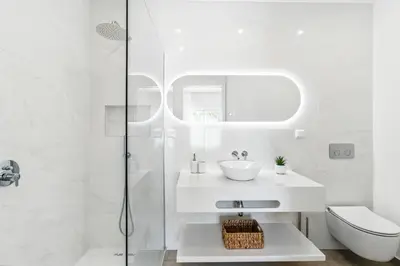 a white bathroom with a sink and a shower at The Oceanfront Villa Luz VR114 in Luz