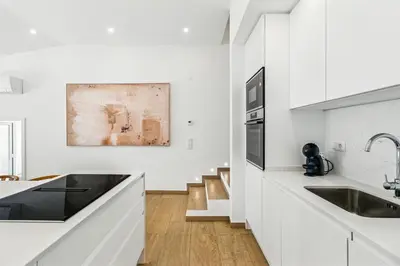 a white kitchen with a sink and a stove at The Oceanfront Villa Luz VR114 in Luz