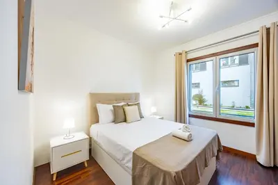 a white bedroom with a bed and a window at Secret Stay Funchal by YOUR KEY in Funchal