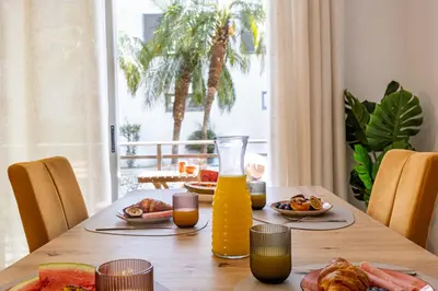 a table with food and a bottle of orange juice at Secret Stay Funchal by YOUR KEY in Funchal