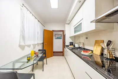 a kitchen with a glass counter top and a table at Secret Stay Funchal by YOUR KEY in Funchal