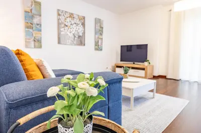 a living room with a blue couch and a tv at Secret Stay Funchal by YOUR KEY in Funchal