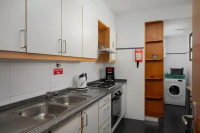 a small kitchen with a sink and a stove at Lobos Horizon by An Island Apart in Câmara de Lobos