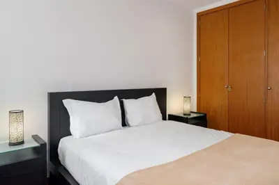 a bedroom with a large bed with two night stands at Lobos Horizon by An Island Apart in Câmara de Lobos