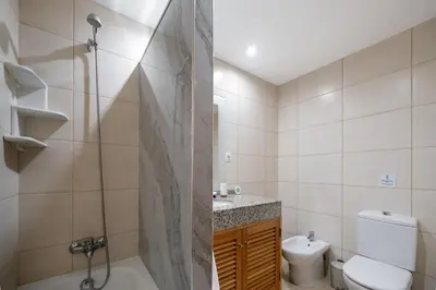 a bathroom with a shower and a toilet and a sink at Lobos Horizon by An Island Apart in Câmara de Lobos