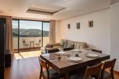 a living room with a table with chairs and a couch at Lobos Horizon by An Island Apart in Câmara de Lobos